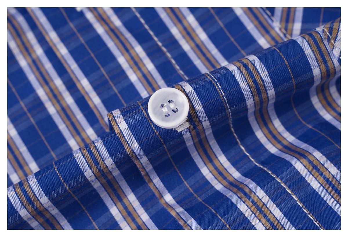 Close-up of a white button on blue plaid shirt fabric.