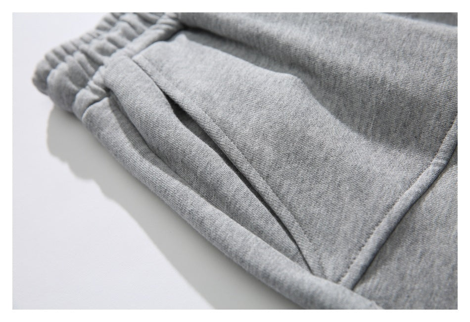 Close-up of a gray shorts pocket opening beside the elastic waistband.