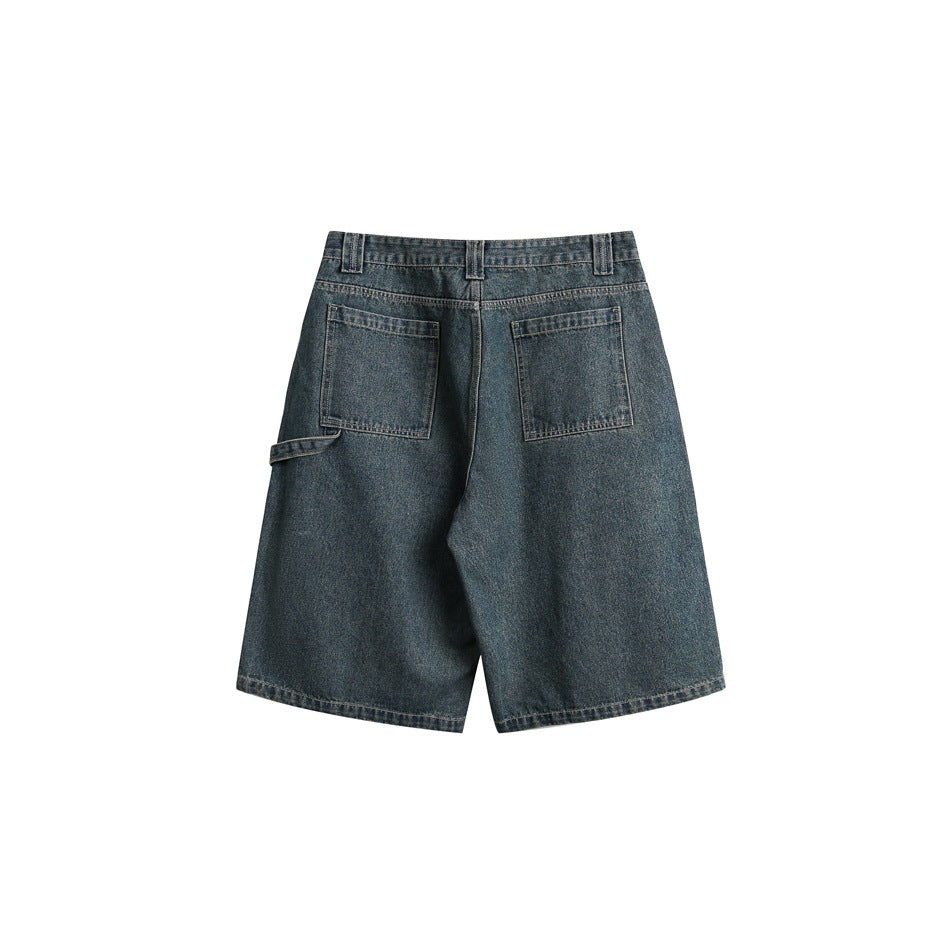Rear view of blue denim knee-length shorts with two back pockets and a small side loop.