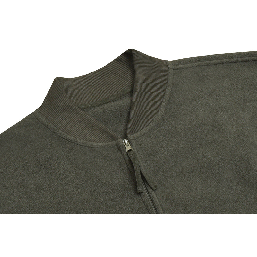 Close-up of an olive-gray jacket's ribbed stand collar and front zipper.
