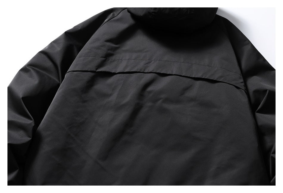 Close-up view of the black jacket back, with a wide horizontal flap across the upper panel.