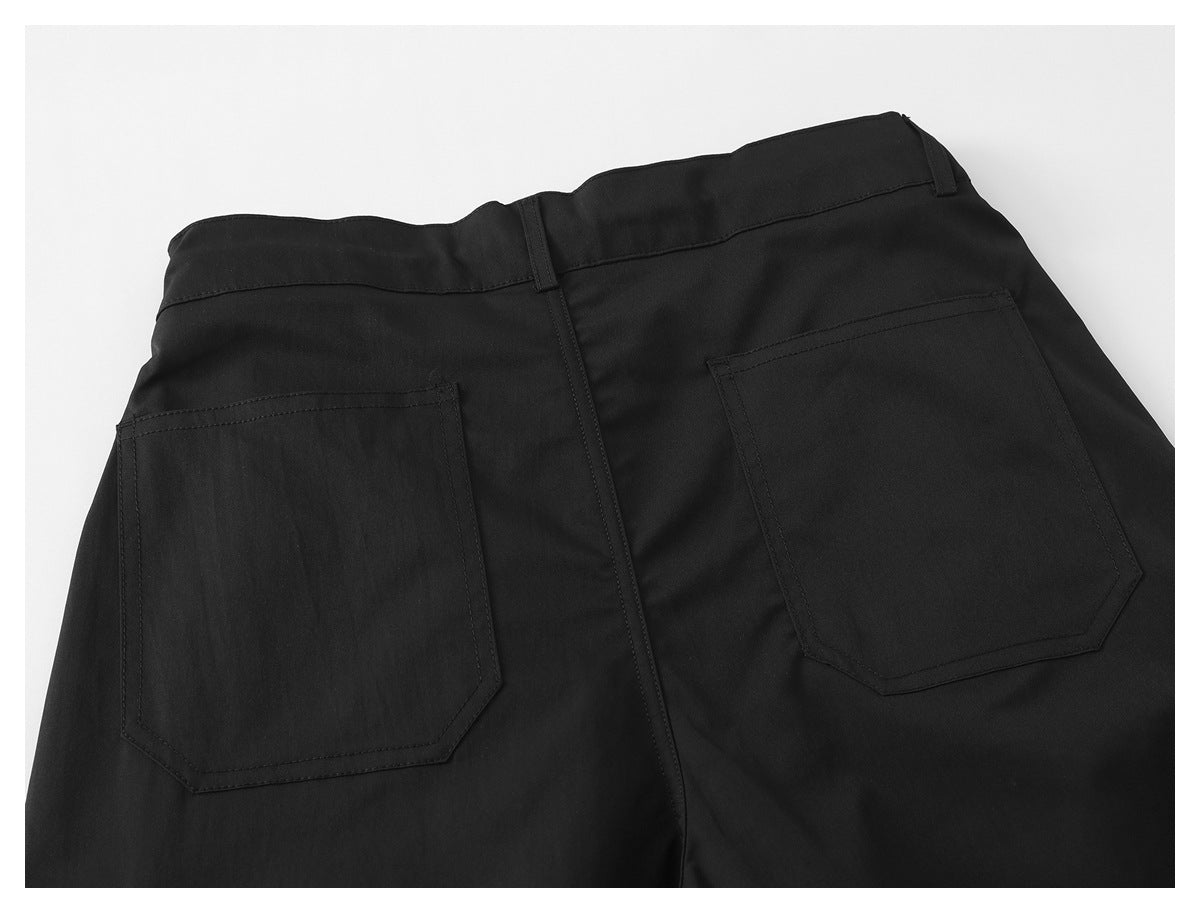 Back view of black trousers laid flat, showing belt loops and two large patch pockets.