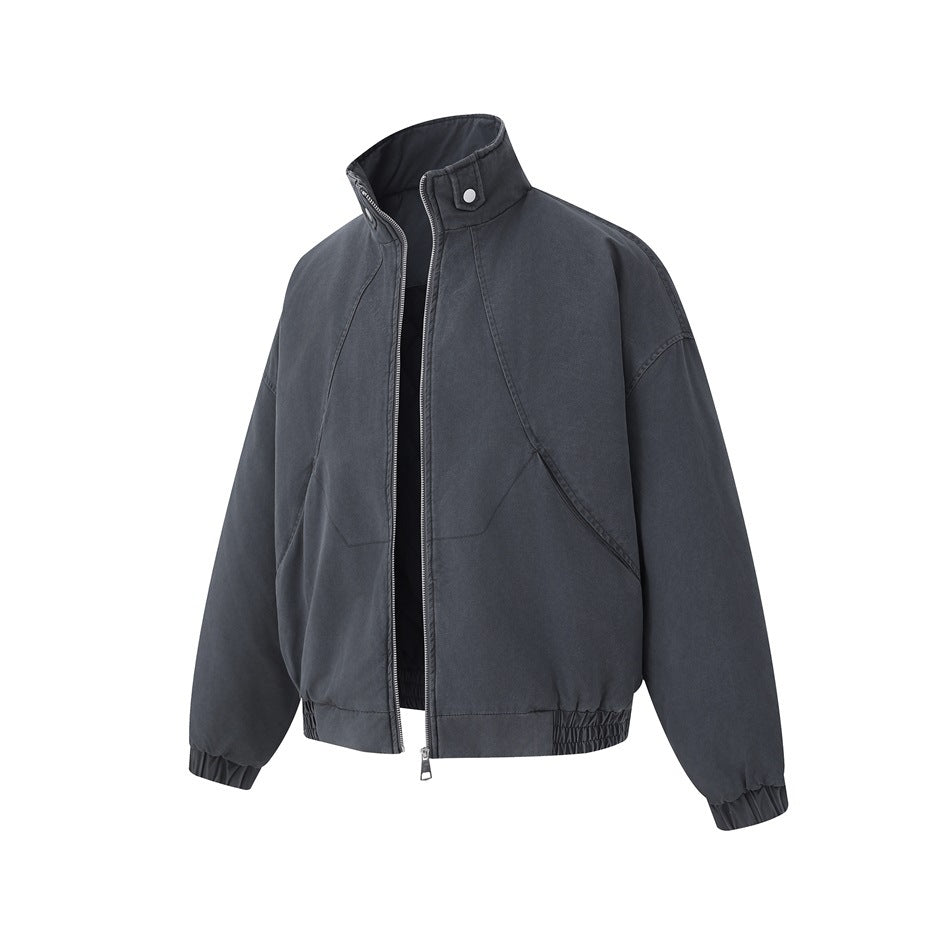 Front view of a charcoal-gray jacket with a stand collar, silver zipper, curved seams, and gathered cuffs and hem.
