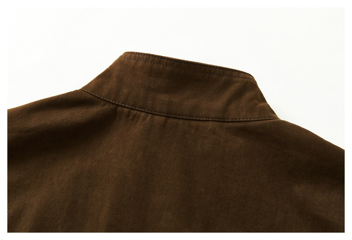 Close-up of the dark brown jacket's raised collar and upper back seam.