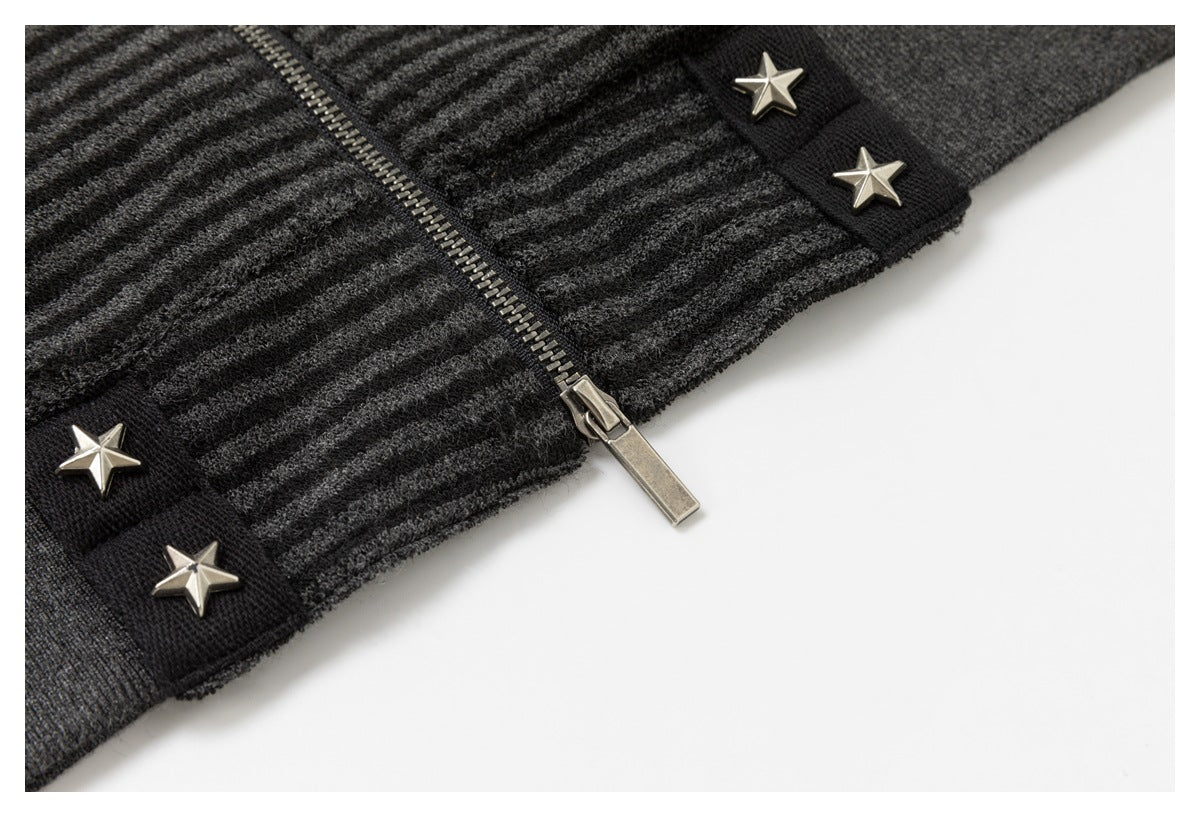 Close-up of the jacket's metal zipper, striped fabric, ribbed hem, and silver star-studded trim.
