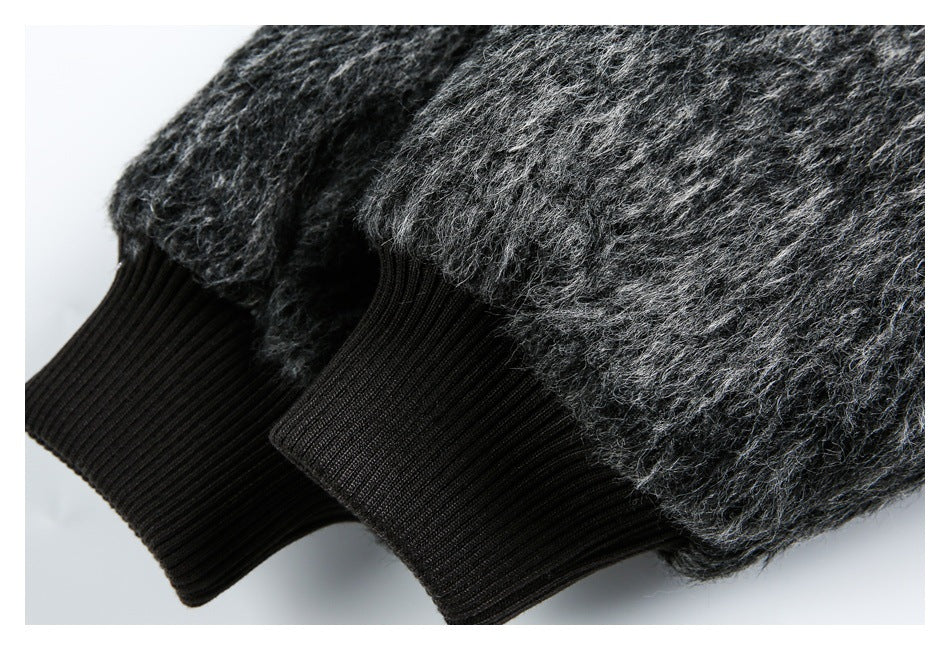 Close-up of two black ribbed cuffs attached to the fuzzy charcoal sleeves of a garment.