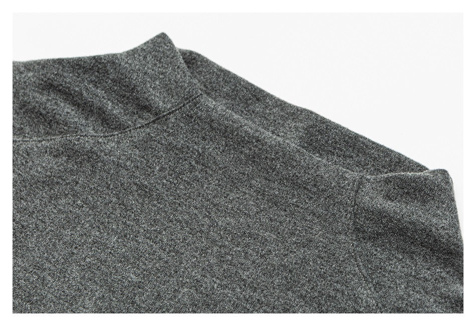 Close-up of a dark gray heathered garment's neckline and shoulder seam.