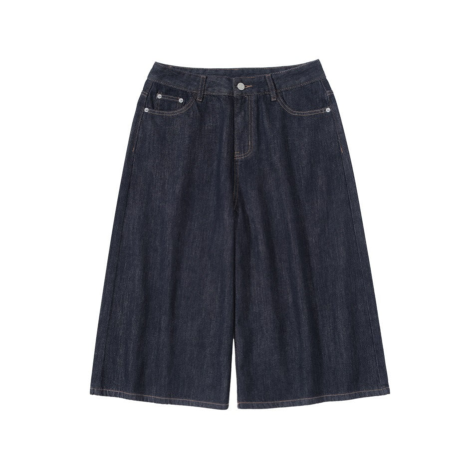Dark indigo wide-leg knee-length denim shorts flat lay, front view with button fly and pockets