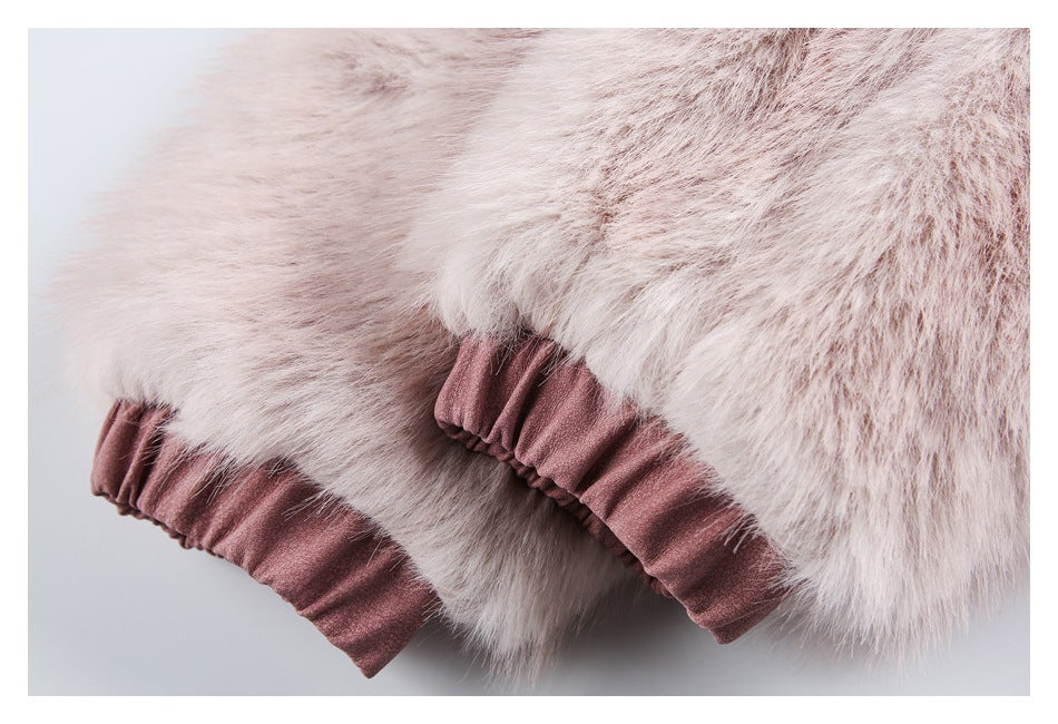 Close-up of pale pink faux fur and gathered rose-pink fabric at the jacket edge.