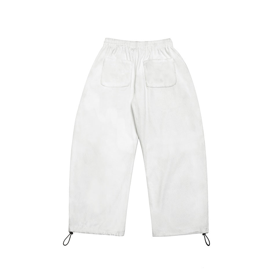 White ribbed wide-leg pants flat lay, back view, with two patch pockets and toggle hems