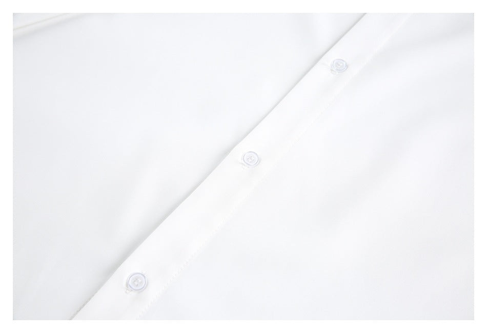 Close-up of a white button placket with three small white buttons.
