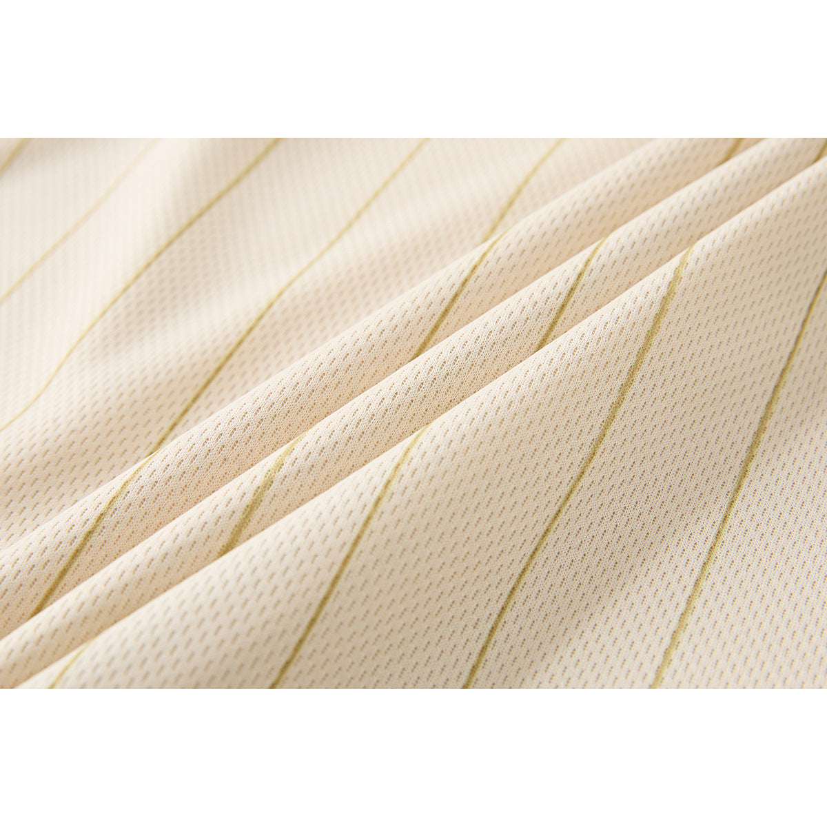 Macro view of cream fabric with fine tan stripes and a small textured knit pattern.