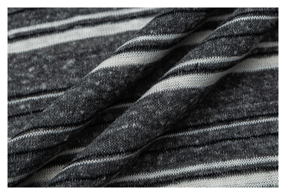 Close-up of the shirt's charcoal and white striped knit fabric, folded to show its texture.
