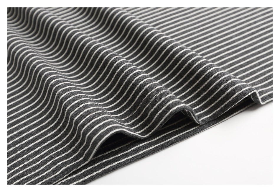 Close-up of charcoal gray and white stripes draped in soft folds.