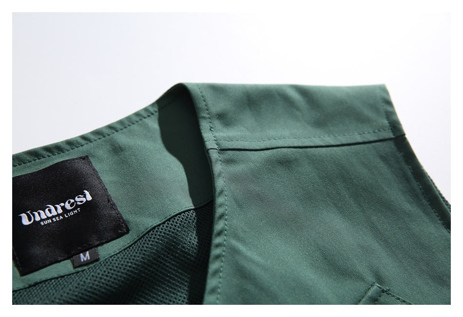 Inside collar detail of a dark green garment, with a branded label, size M tag, and mesh lining.