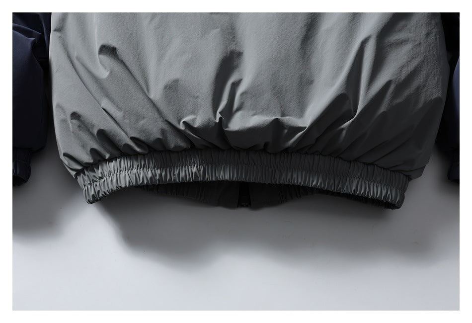 Close-up of the jacket's gathered elastic hem and light gray back panel.