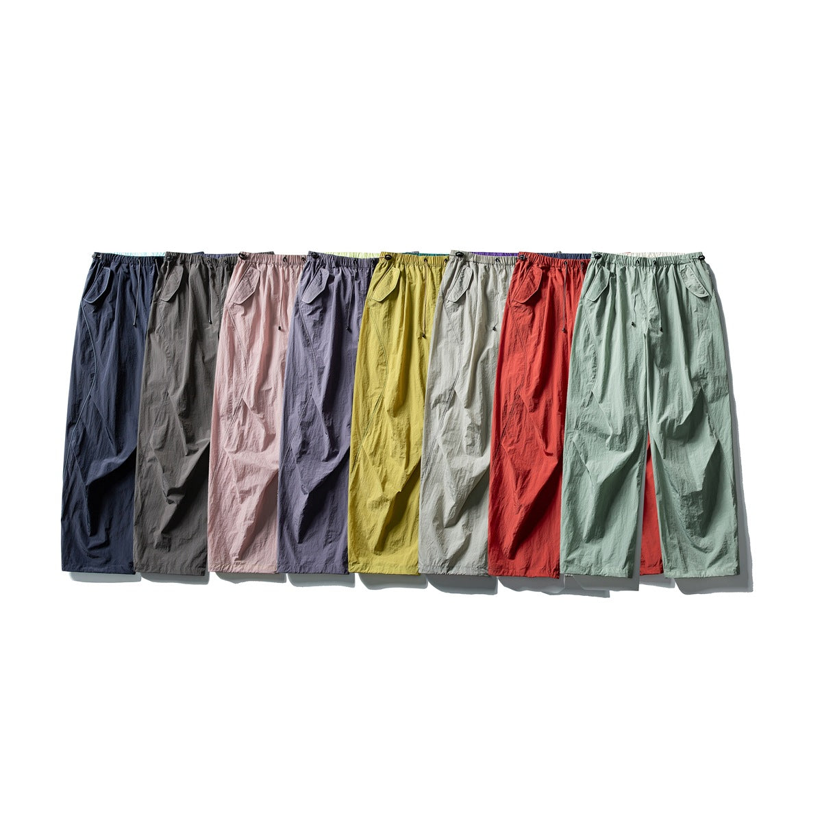 Loose drawstring pants displayed together in navy, gray, pink, lavender, yellow, light gray, red, and sage green.