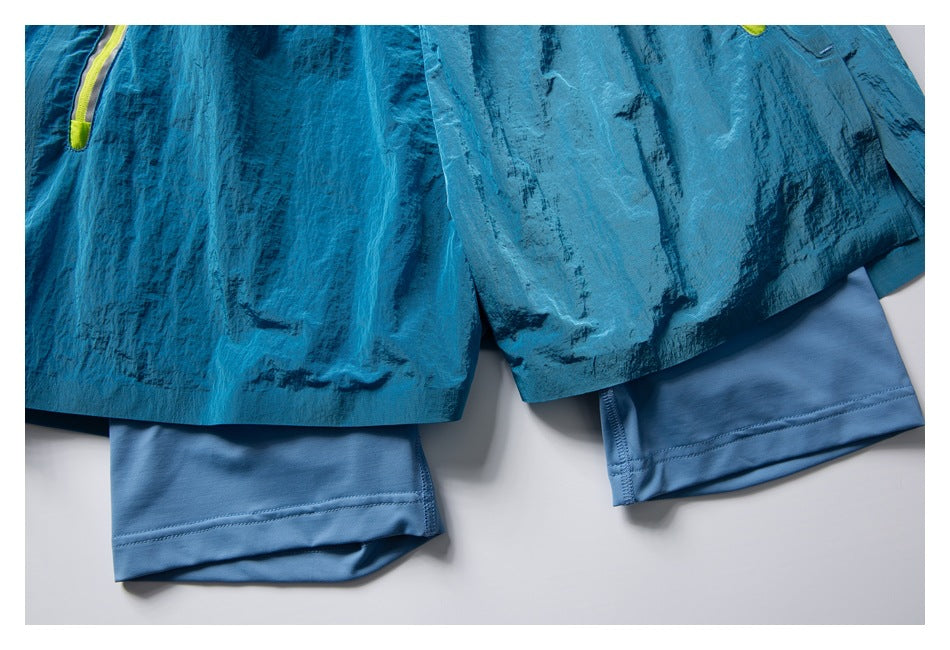 Close-up of turquoise running shorts layered over light blue compression shorts at the hems.