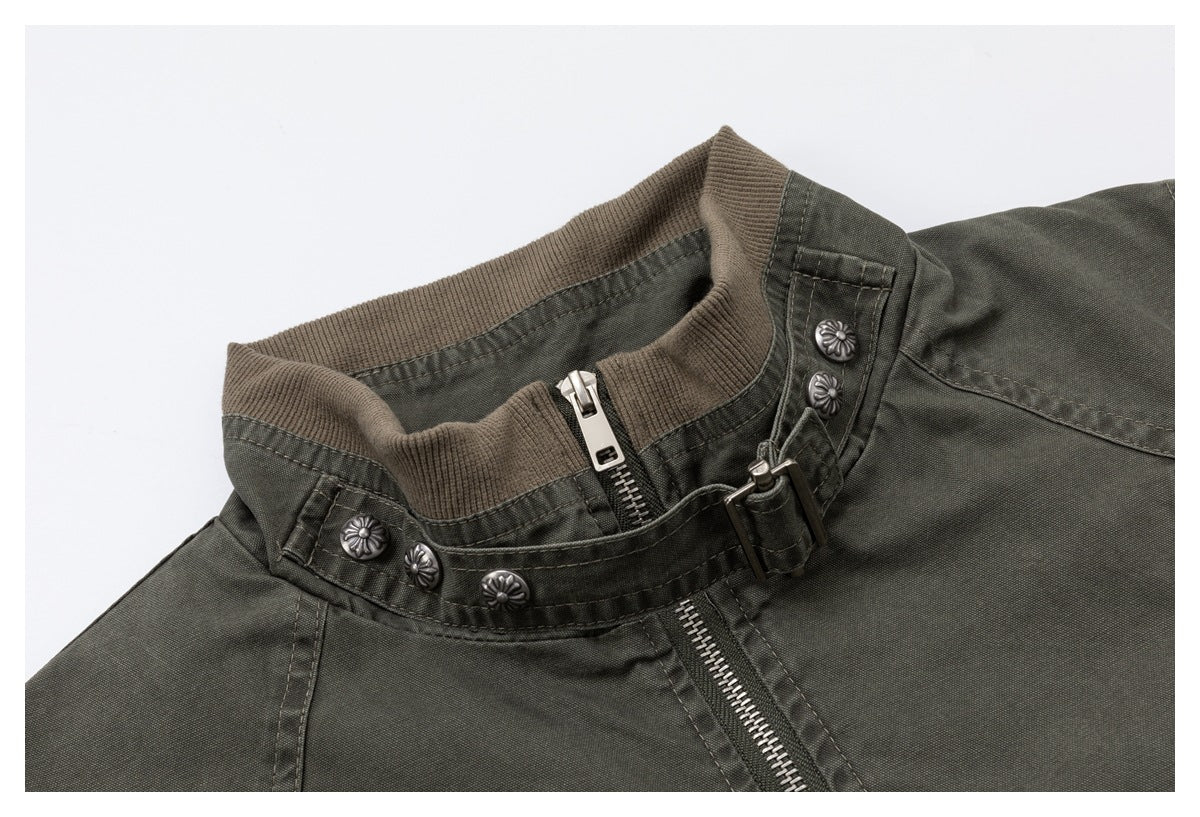 Close-up of the jacket's ribbed stand collar, metal zipper, buckle strap, and decorative buttons.