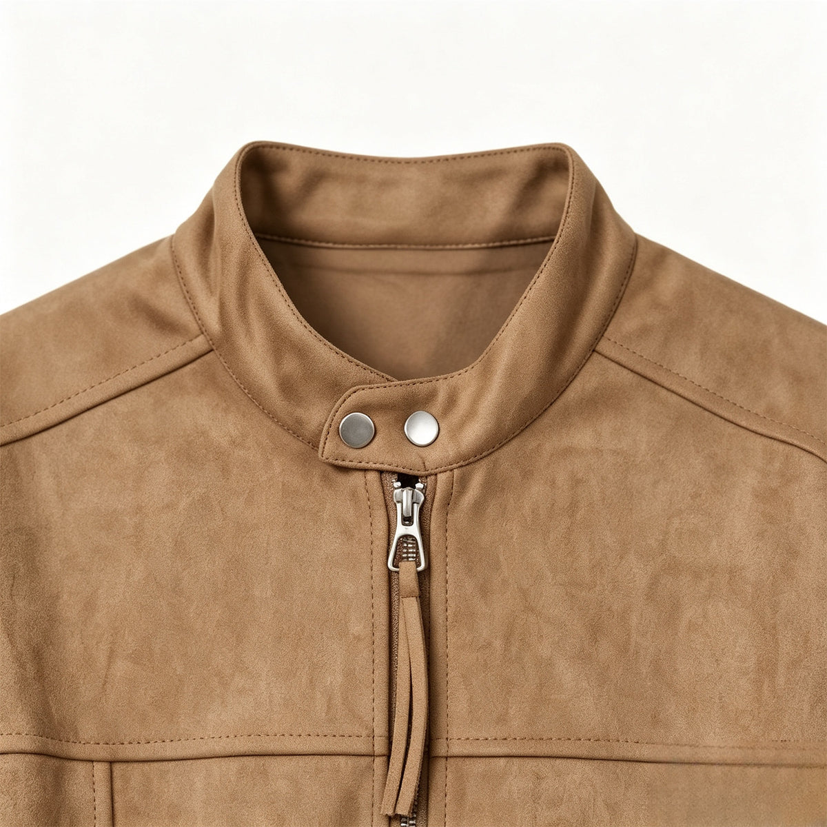 Close-up of a tan jacket’s stand collar, snap buttons, front zipper, and stitched chest panels.