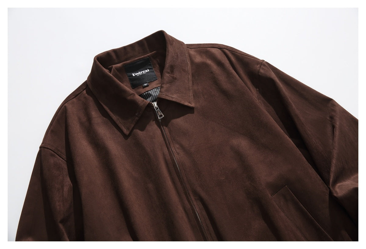 Cropped front view of a dark brown jacket laid flat, with a pointed collar, center zipper and angled pocket.