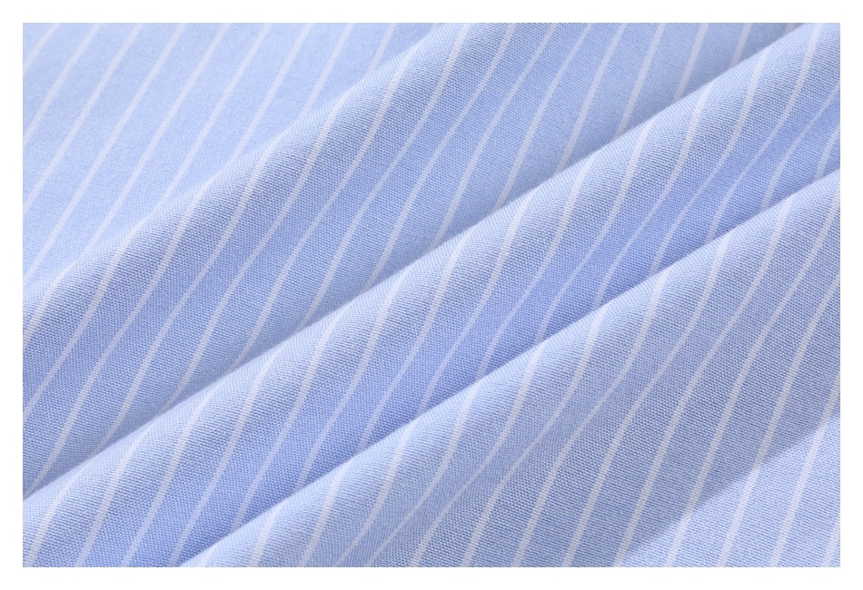 Close-up of light blue fabric with evenly spaced white pinstripes, folded into soft diagonal drapes.