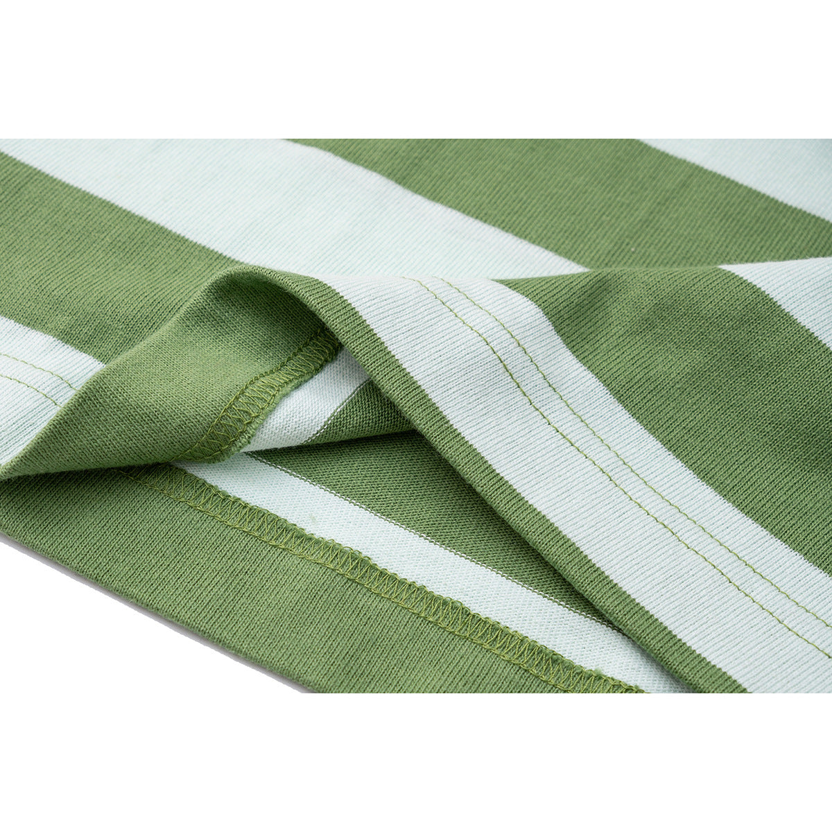 Close-up of the double-stitched hem and overlocked seam on a green-and-white striped T-shirt.