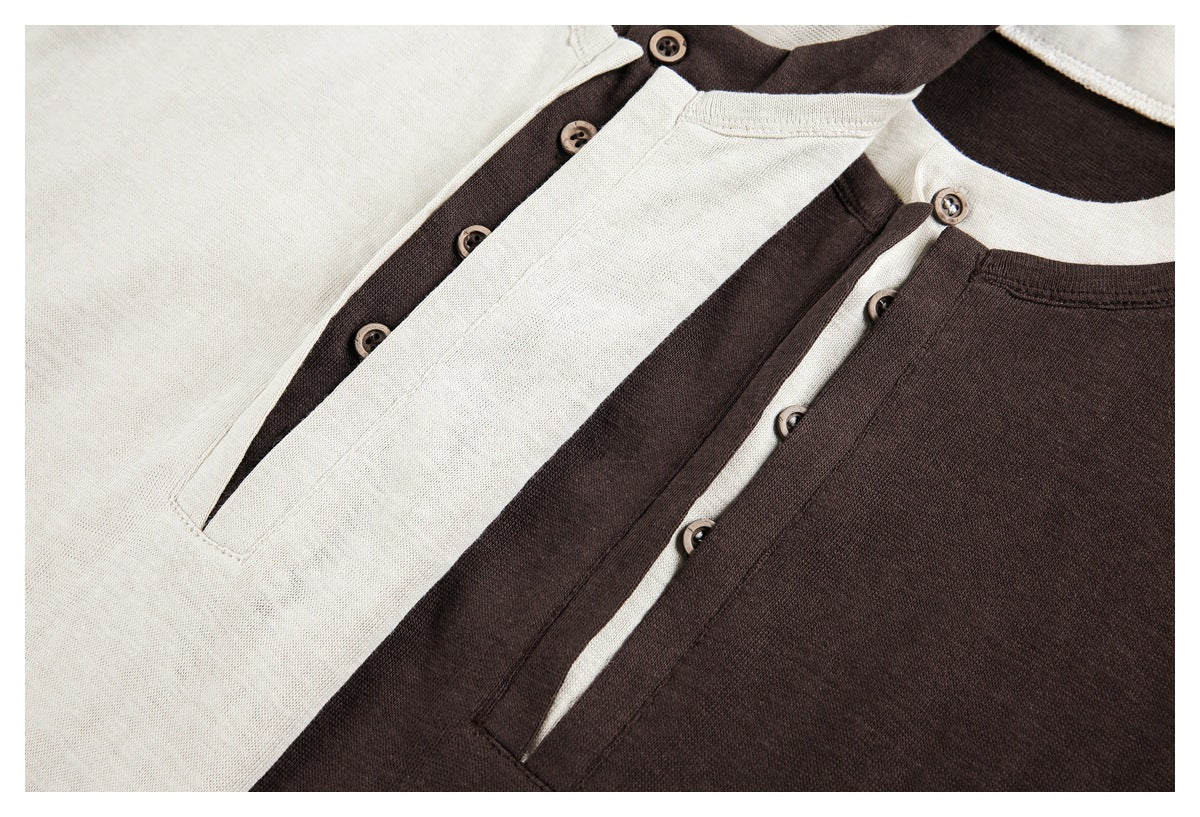 Close-up of cream and dark brown Henley shirts with contrasting plackets and buttons.