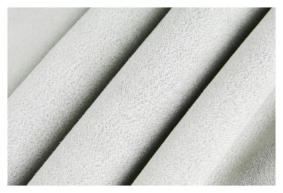 Extreme close-up showing the fine textured weave of light gray fabric.