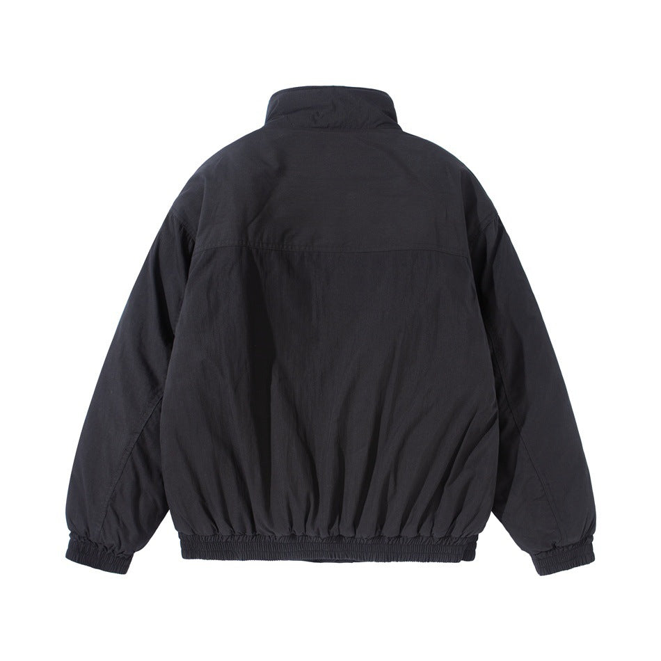 Black stand-collar jacket, back flat lay, showing yoke seam, gathered hem and elastic cuffs