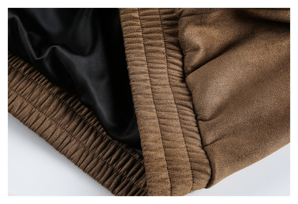 Inside close-up of the brown jacket showing black lining beside its gathered waistband.
