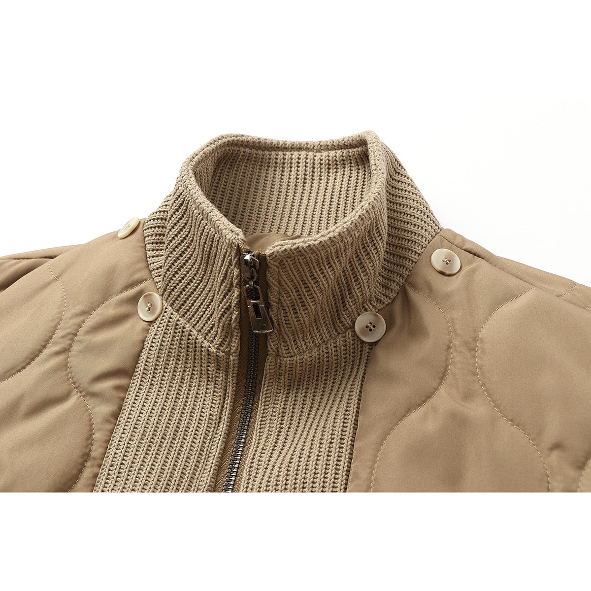 Close-up of a tan quilted jacket with a rib-knit stand collar, zipper, and shoulder buttons.