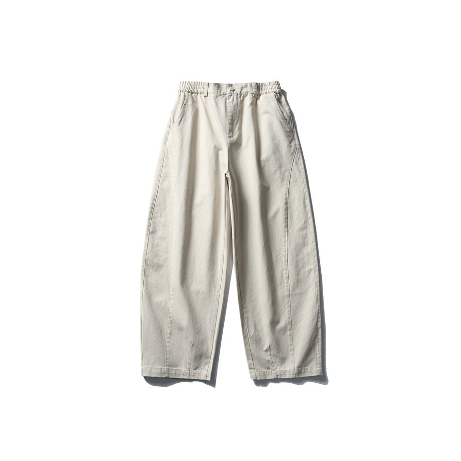 Front view of apricot beige wide-leg pants with elastic waistband, button fly and side pockets, flat lay