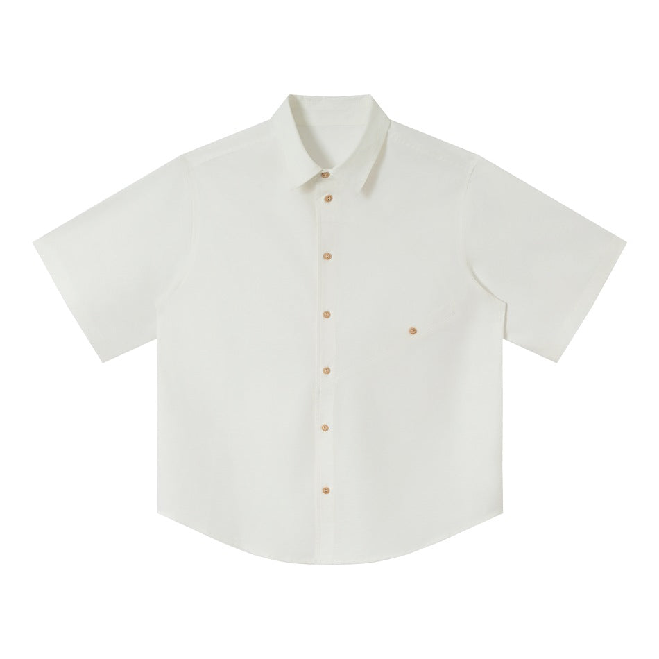 White short-sleeve button-up shirt flat lay with point collar, wood-tone buttons and diagonal chest pocket