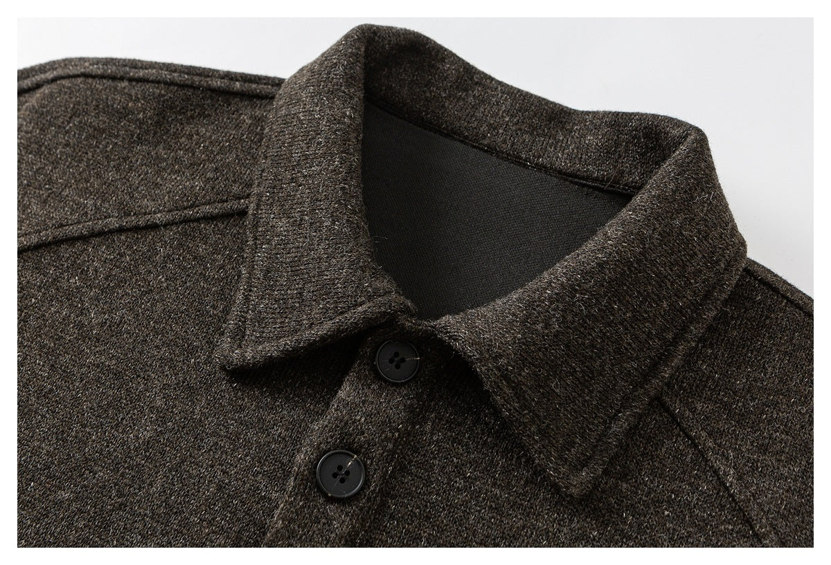 Close-up of a dark brown flecked coat collar and front with two black buttons.