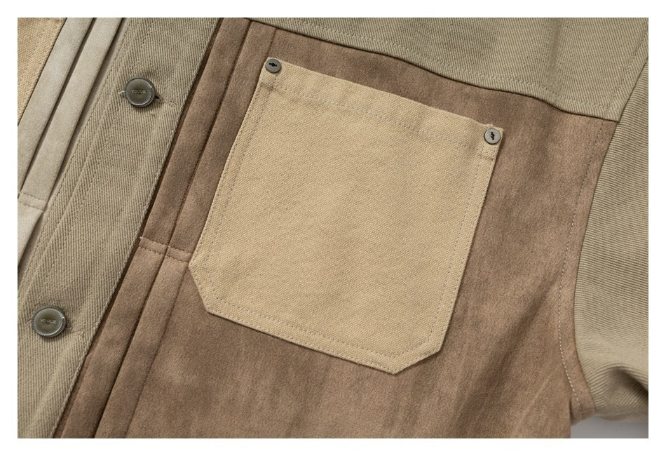 Close-up of a pale beige patch pocket on a brown jacket panel, with stitching and metal buttons.