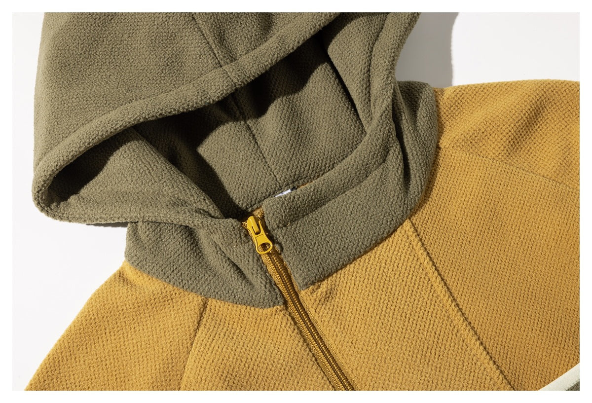 Close-up of a mustard and olive hooded jacket showing the hood, collar, and yellow front zipper.