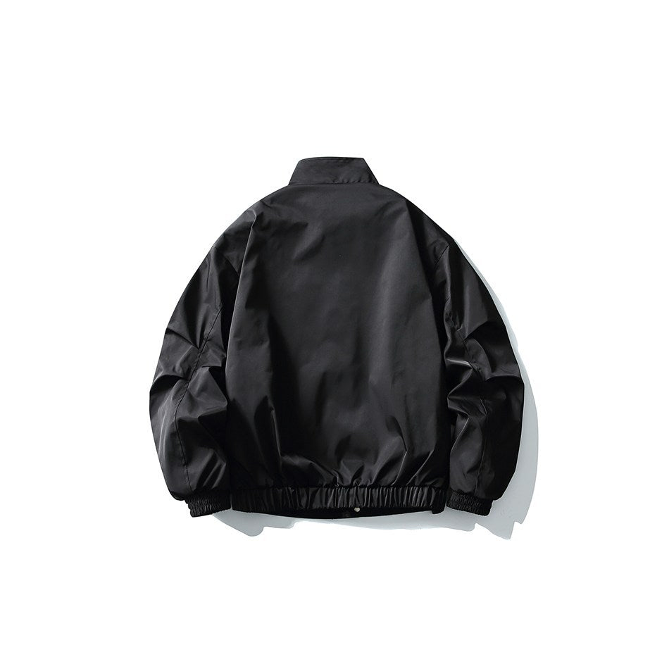 Back view of black stand-collar jacket with elastic hem and cuffs, flat lay on white