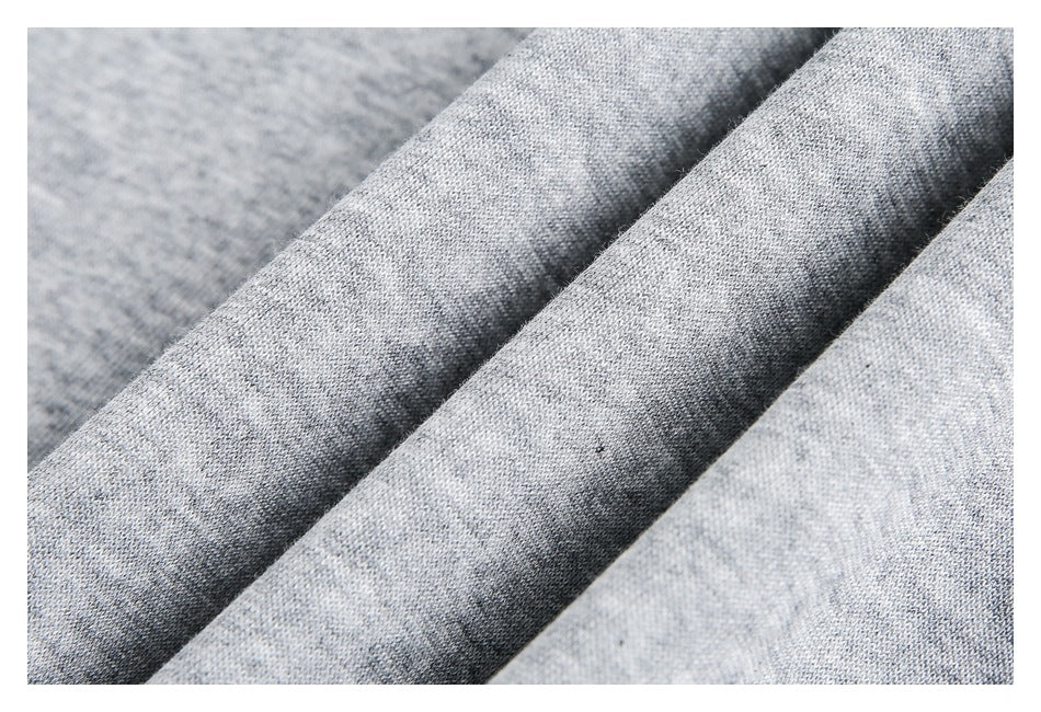 Close-up of folded gray heathered knit fabric showing its texture.