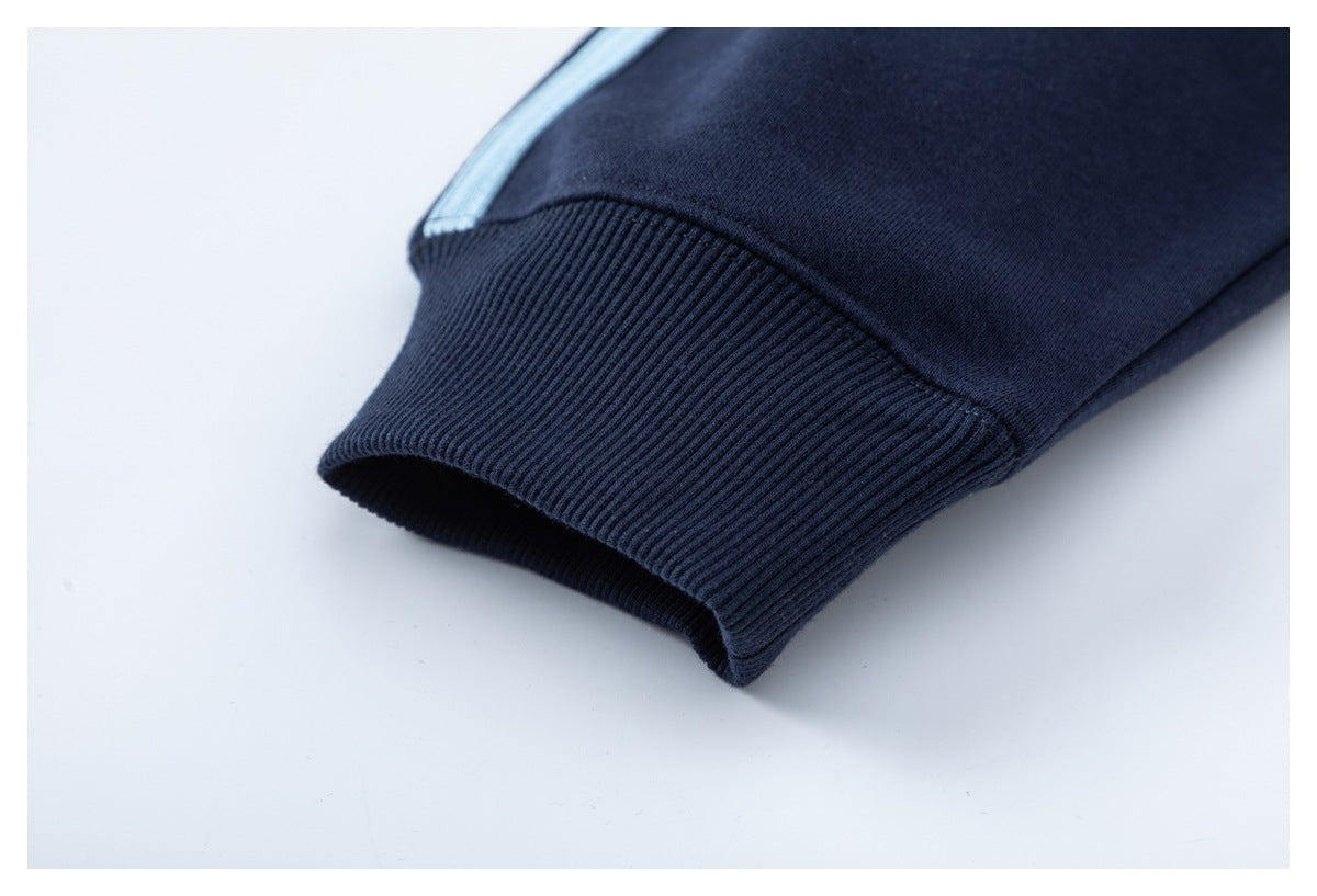 Close-up of a dark navy sleeve cuff with ribbed trim and a light blue stripe.