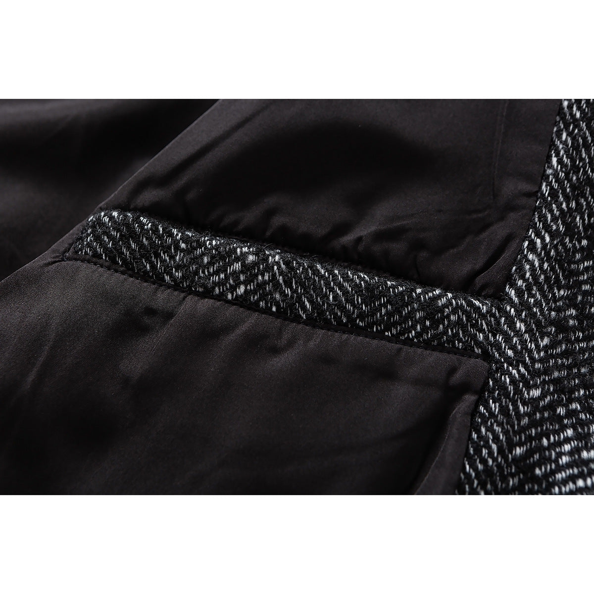Close-up of the jacket's dark lining and a herringbone-trimmed interior seam.