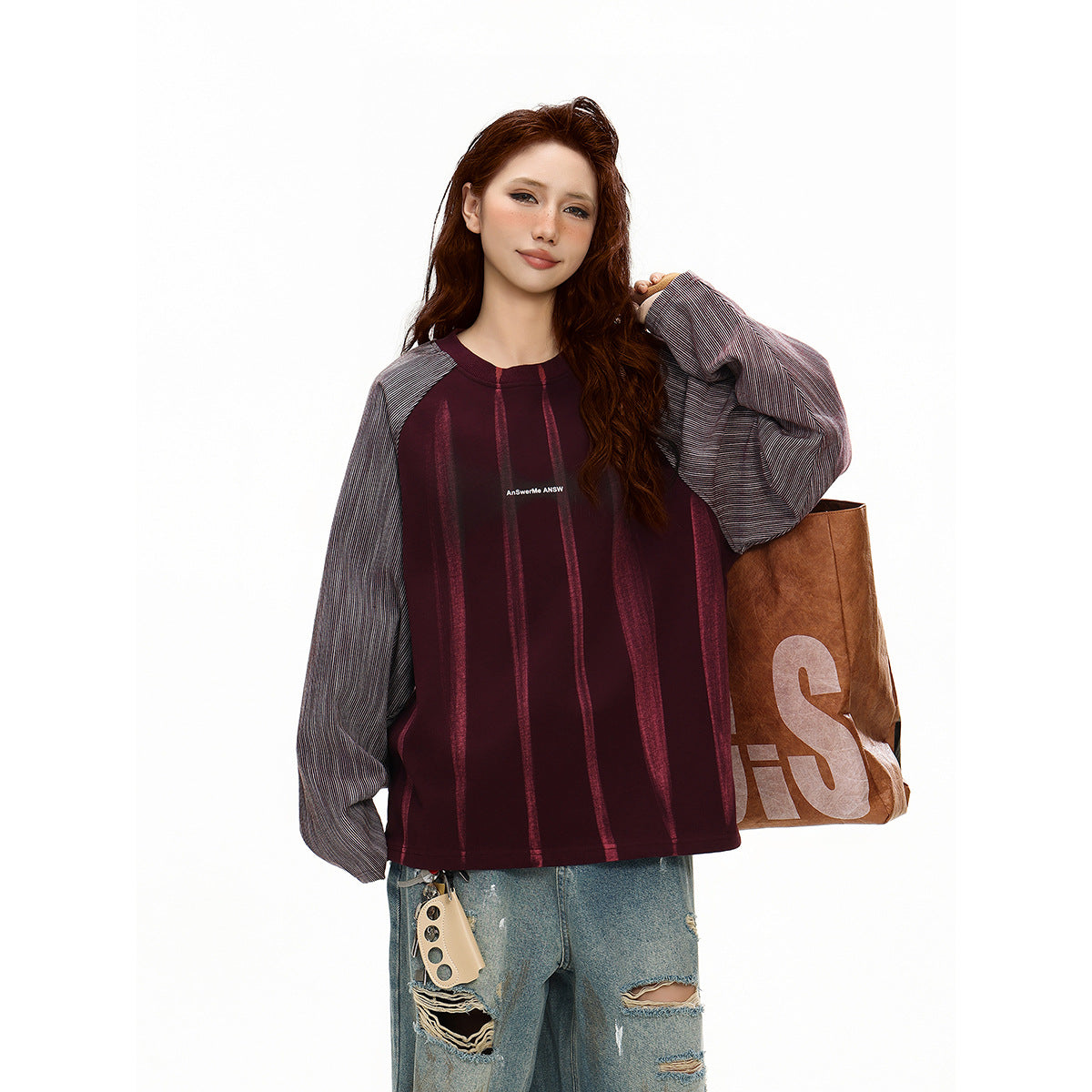 Model wearing a burgundy top with distressed vertical stripes and gray pinstriped raglan sleeves.