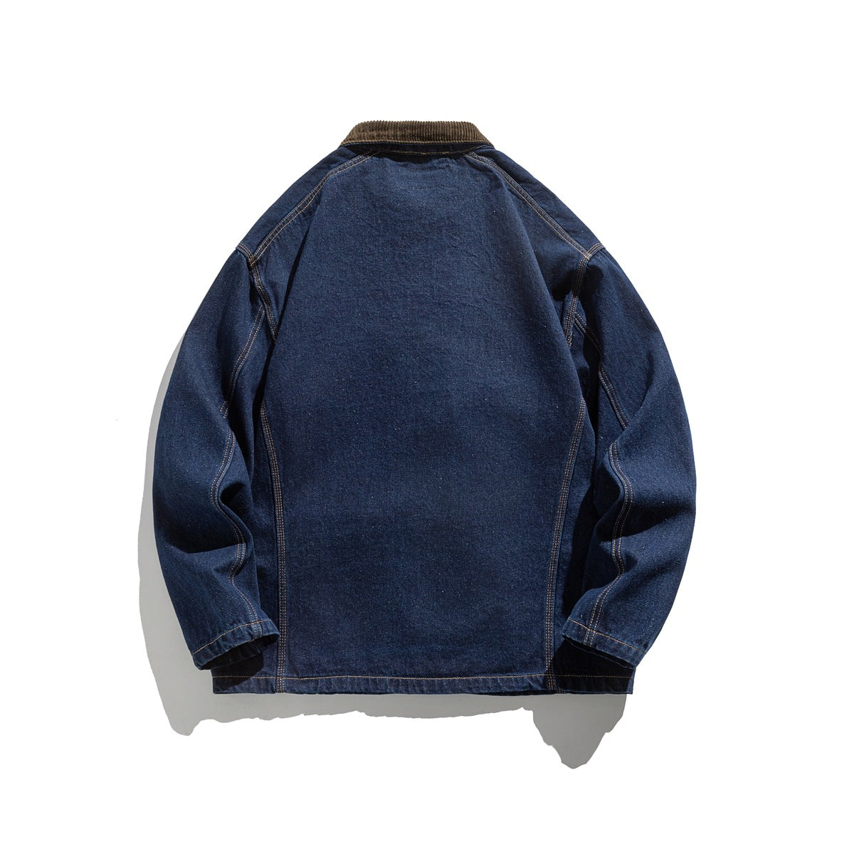 Back view of a dark blue denim jacket laid flat, with long sleeves, golden seams, and a brown collar.