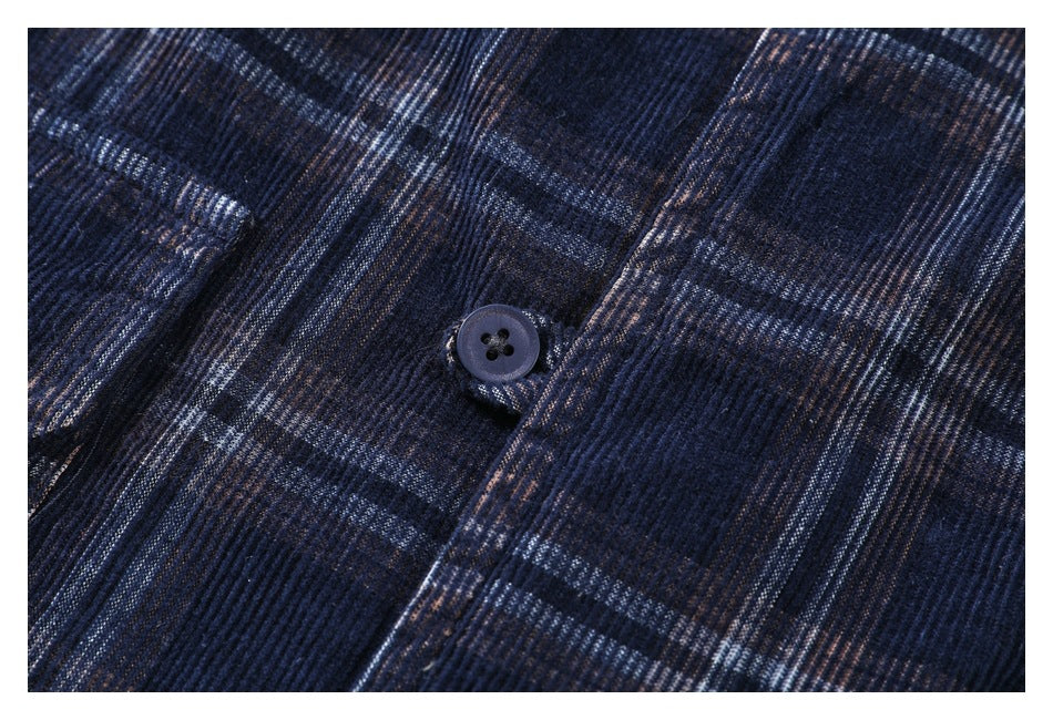 Close-up of a dark button on dark navy plaid shirt fabric.