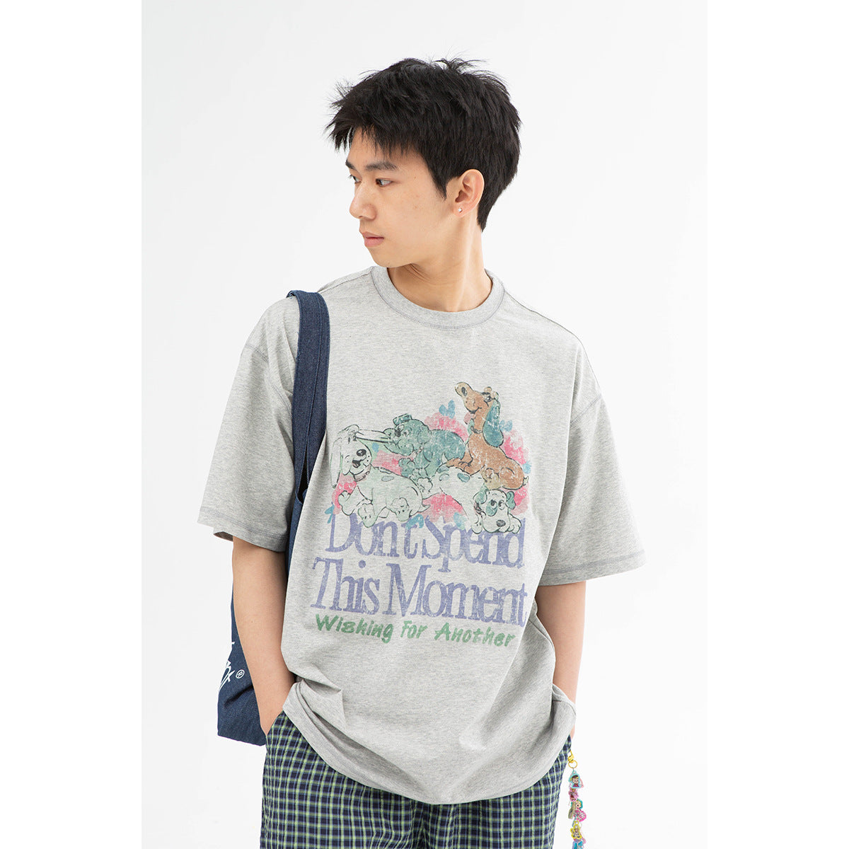 Close view of a gray T-shirt with a colorful animal illustration and English lettering on the front.