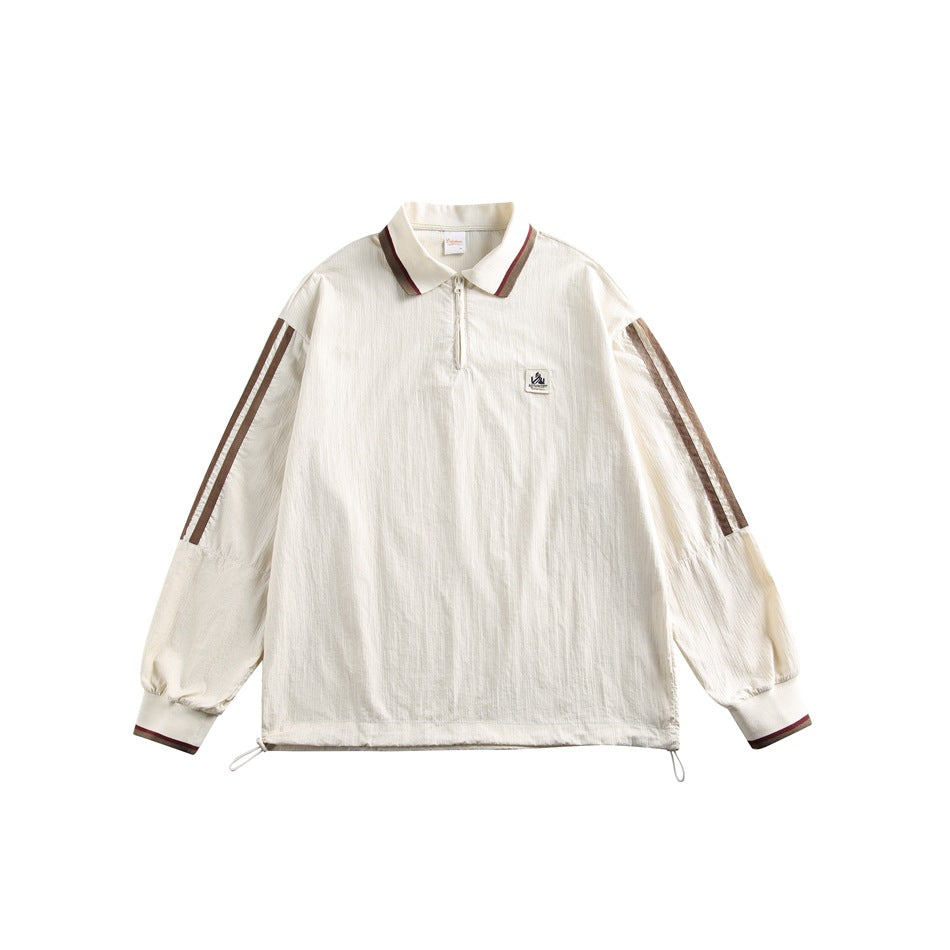 Front view of an ivory quarter-zip pullover with brown sleeve stripes, collar accents, and an adjustable drawcord hem.