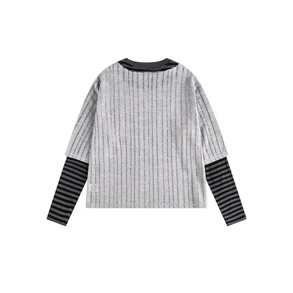 Back view of a gray short-sleeve T-shirt with thin vertical stripes, layered over long dark gray and black striped sleeves.