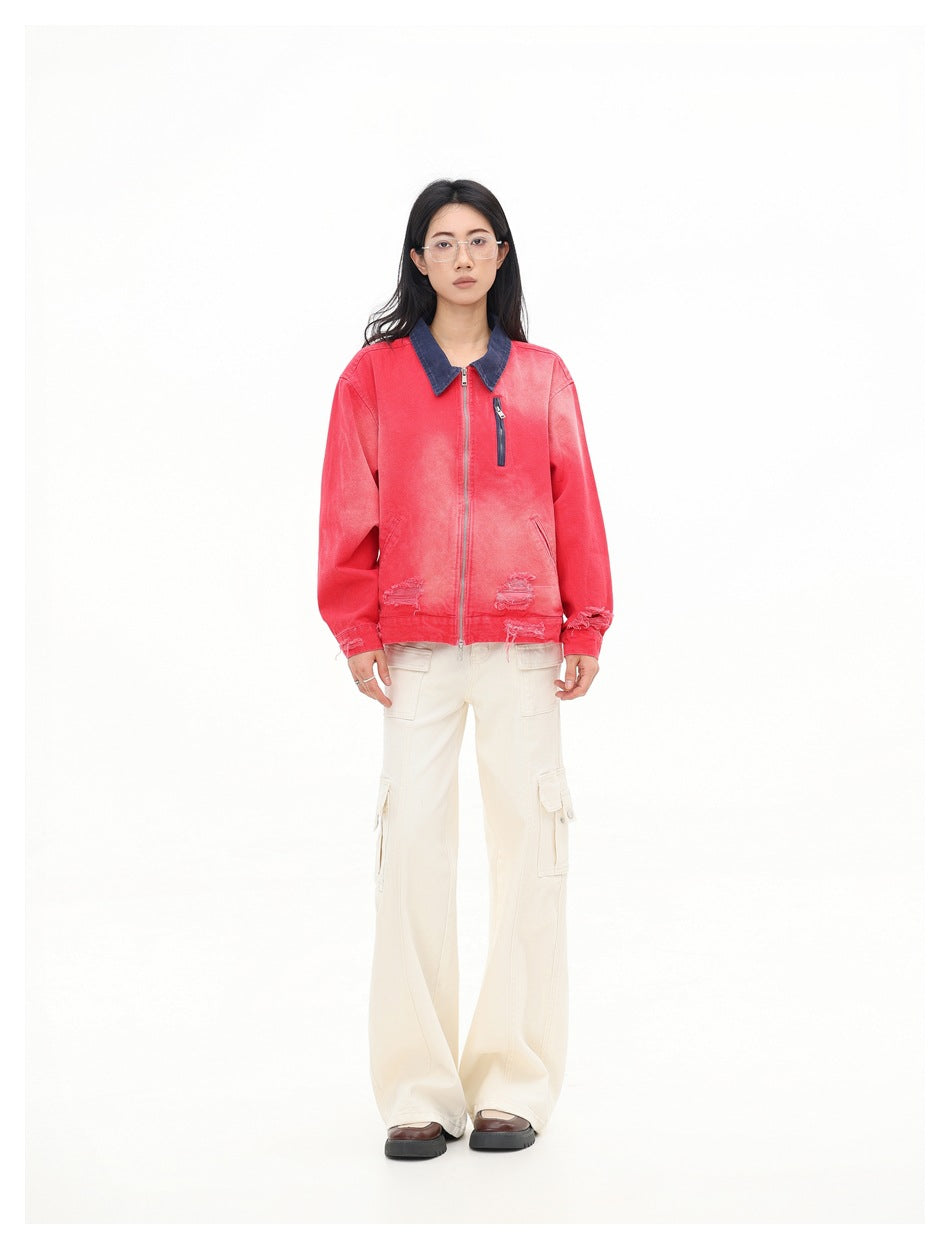 Full-length front view of a model wearing a coral-red zip jacket with a dark blue collar and cream cargo pants.