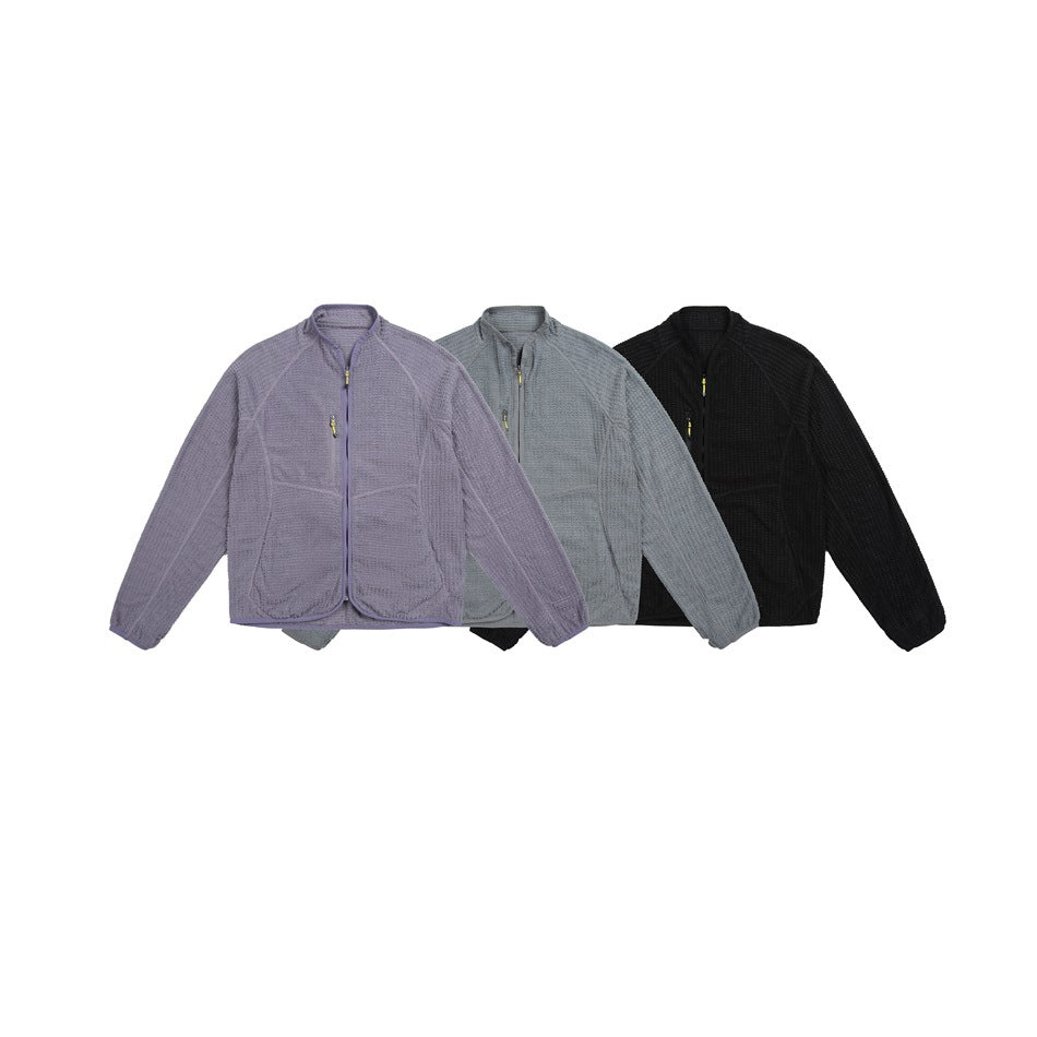 Three front-view textured zip jackets arranged together in lavender, gray, and black.