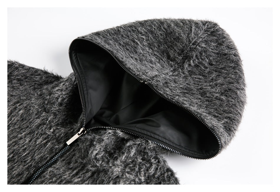 Close-up of the dark gray fuzzy jacket's open hood, black lining, and zipper.